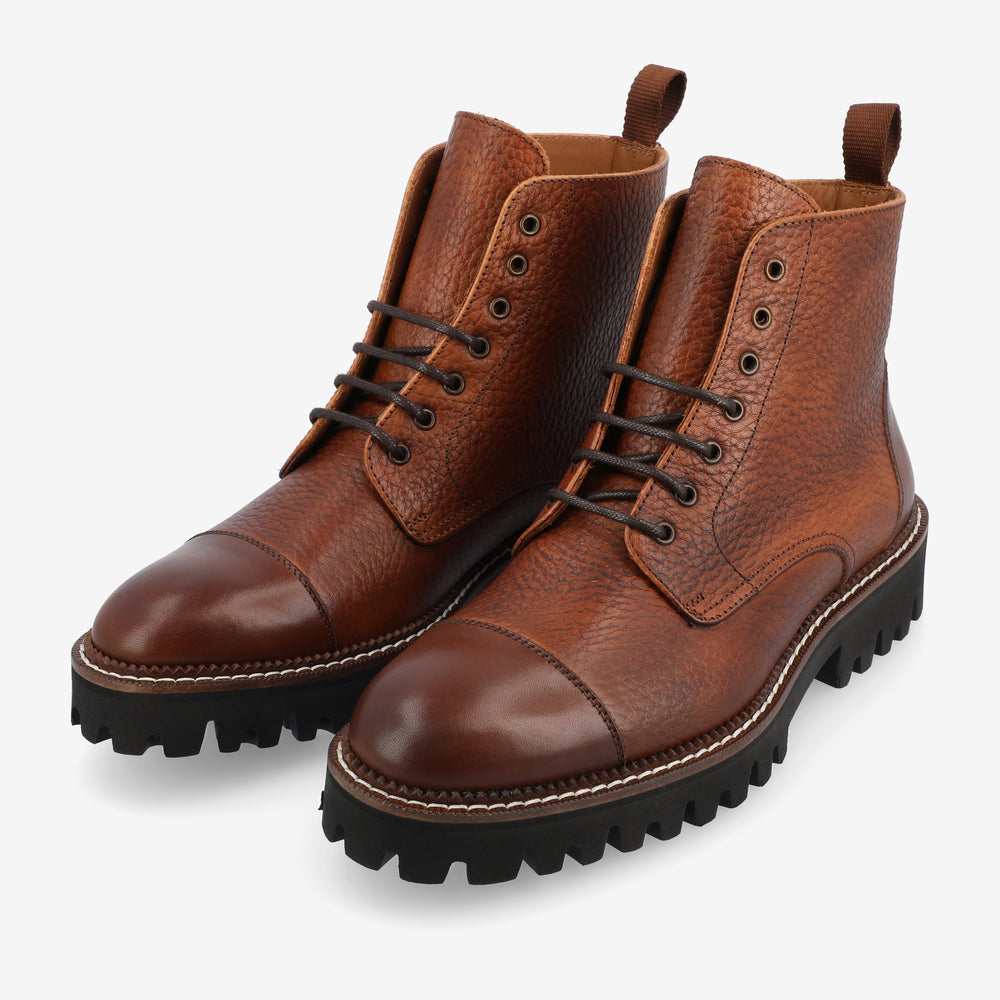 Pair of brown leather lace-up ankle boots with black rugged soles, displayed side by side on a white background.