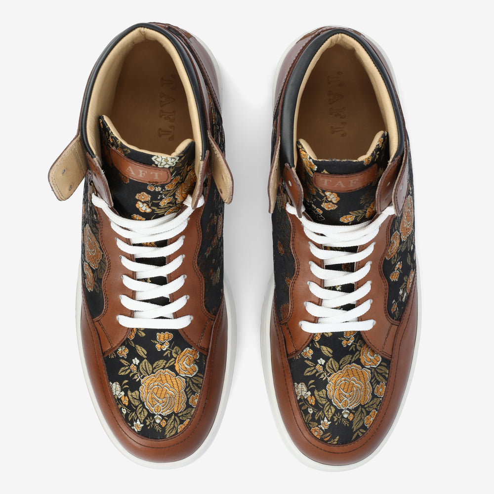 Top view of a pair of high-top sneakers with brown leather accents and floral-patterned fabric panels, featuring white laces.