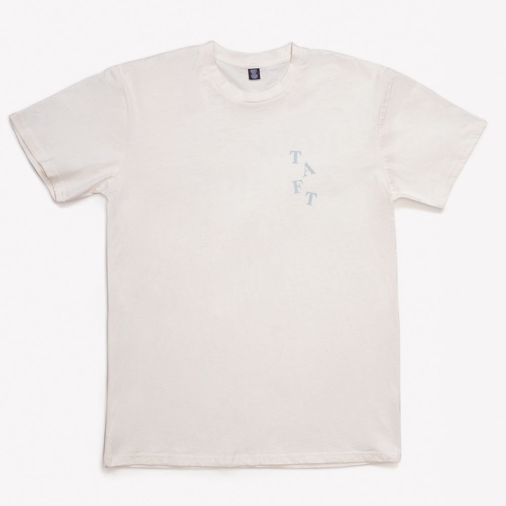 A plain, short-sleeve white T-shirt with the word TAFT printed in a pale blue color on the left chest area.