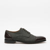 A grey and brown dress shoe with laces, featuring a leather toe and heel on a flat black sole, shown against a plain white background.
