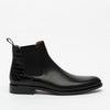 A black leather Chelsea boot with a crocodile texture heel and elastic side panels, shown against a white background.
