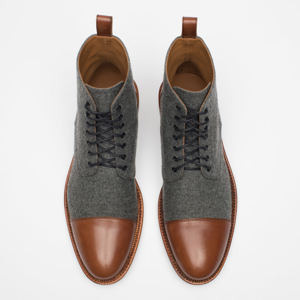 A pair of gray and brown oxford boots, viewed from above.
