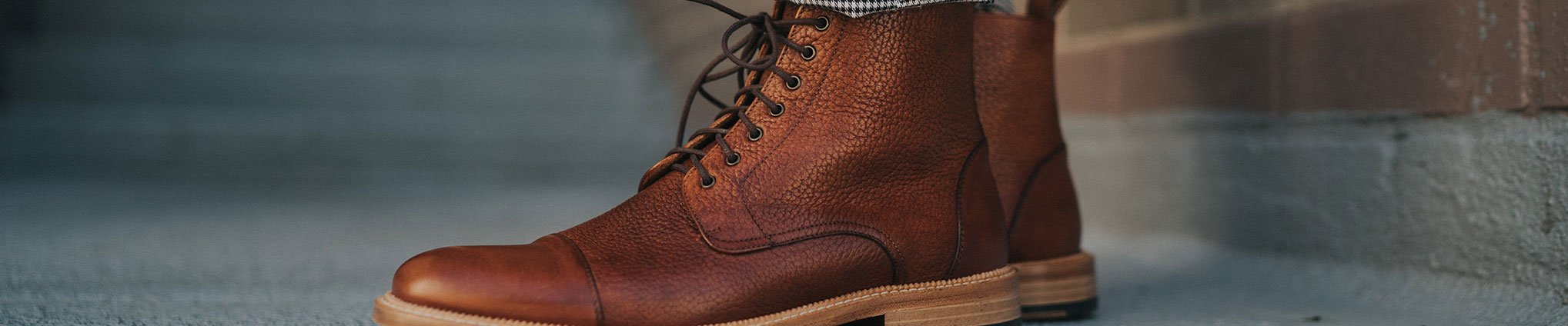 male model walking in rome boots in brown