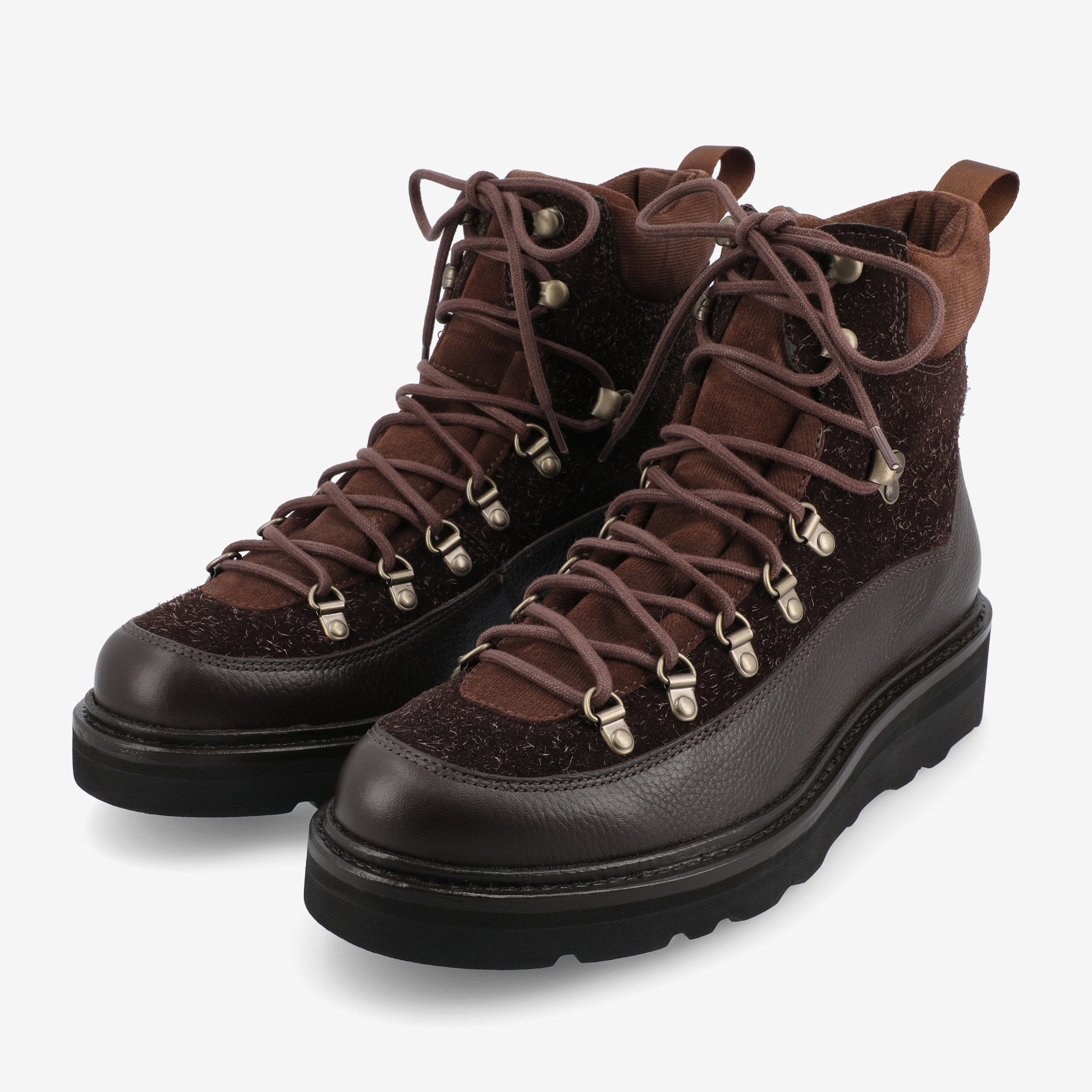 A pair of dark brown leather hiking boots with black rubber soles and brown laces, featuring metal eyelets and hooks for lacing.