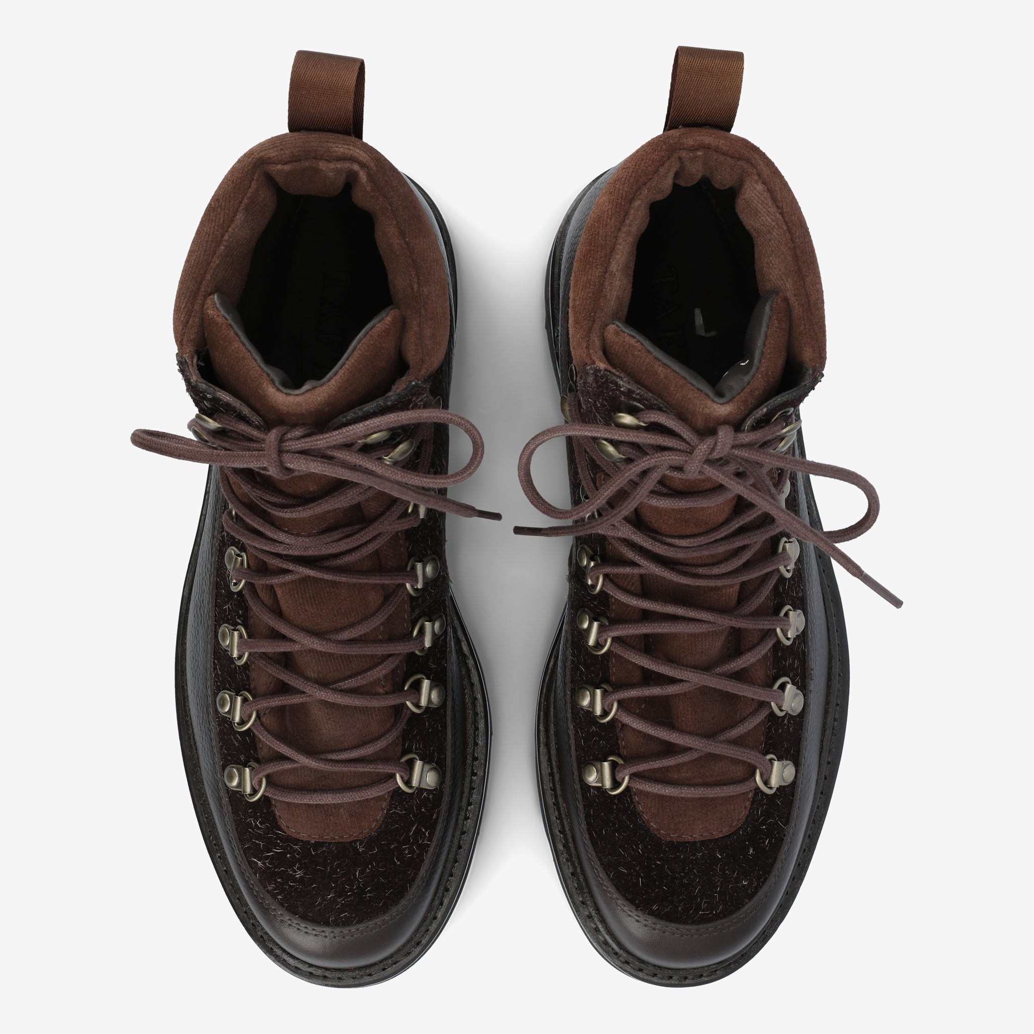 Top view of a pair of brown hiking boots with brown laces and metal eyelets, set against a neutral background.