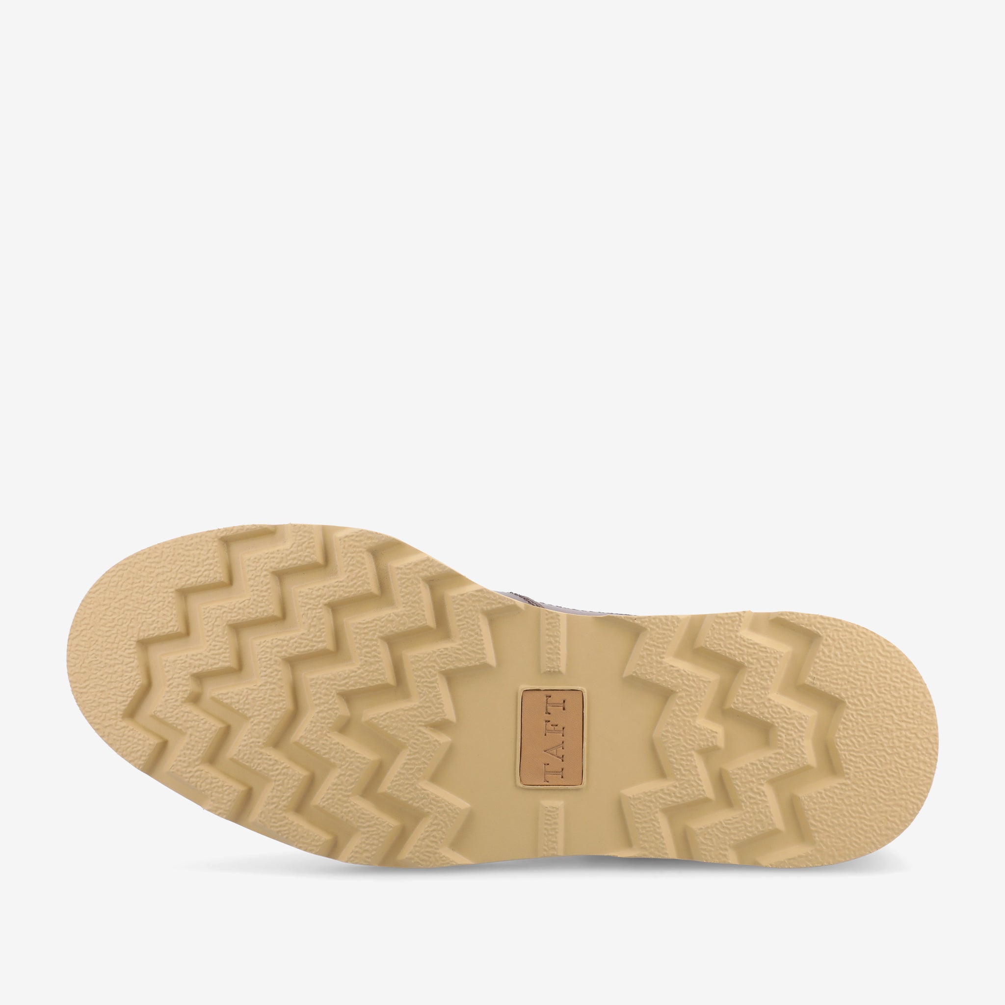 The image shows the sole of a beige shoe with a zigzag tread pattern and a small rectangular logo in the center.