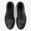 A pair of black and grey lace-up brogues with textured fabric panels and perforated detailing, viewed from above.