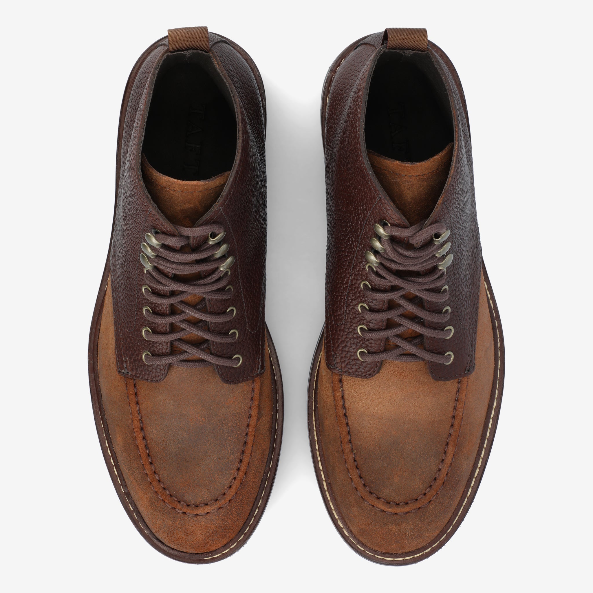 Top view of a pair of brown lace-up leather shoes with two tones, darker around the top and lighter on the toe area.