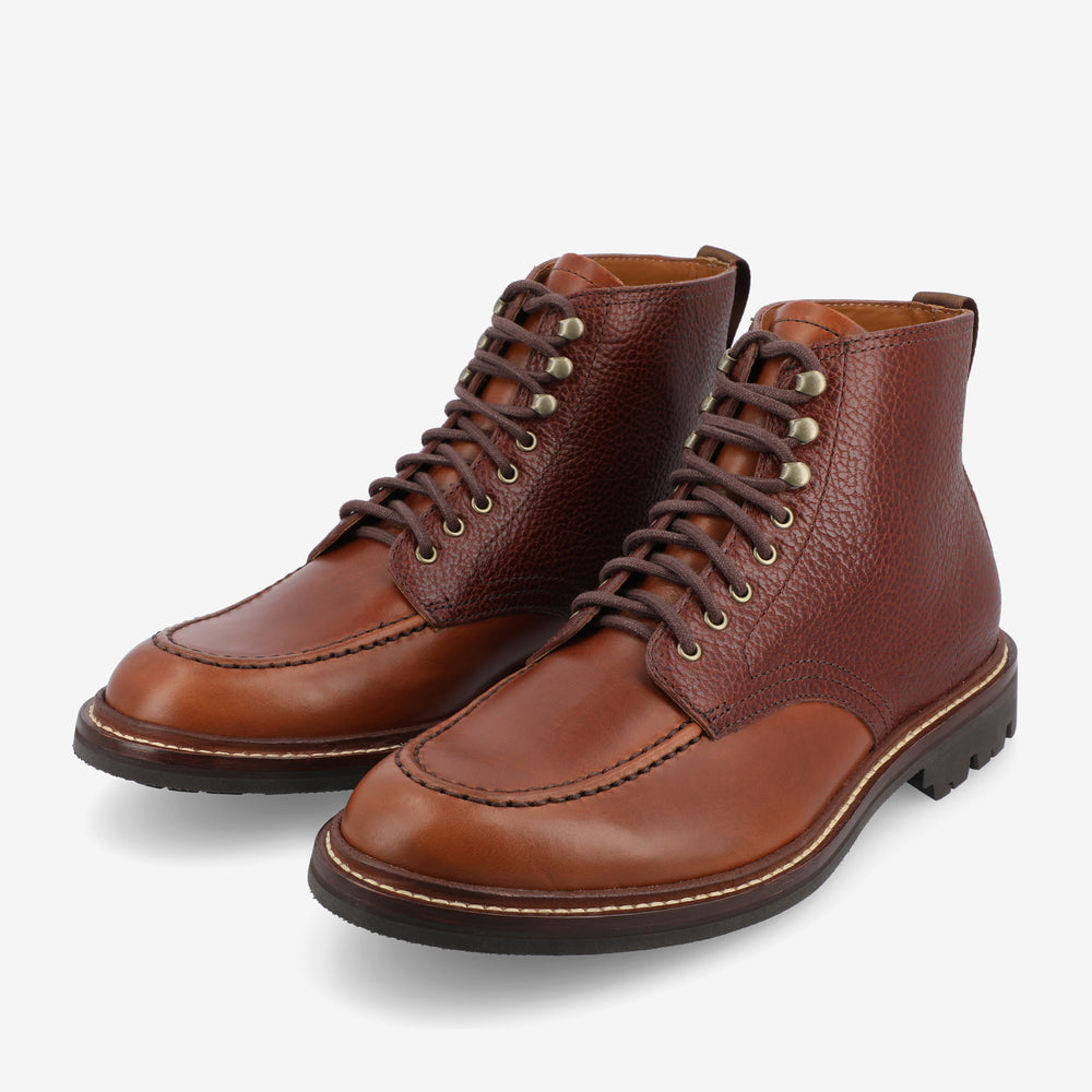 A pair of brown leather lace-up boots with rugged soles, featuring detailed stitching and a two-tone design.