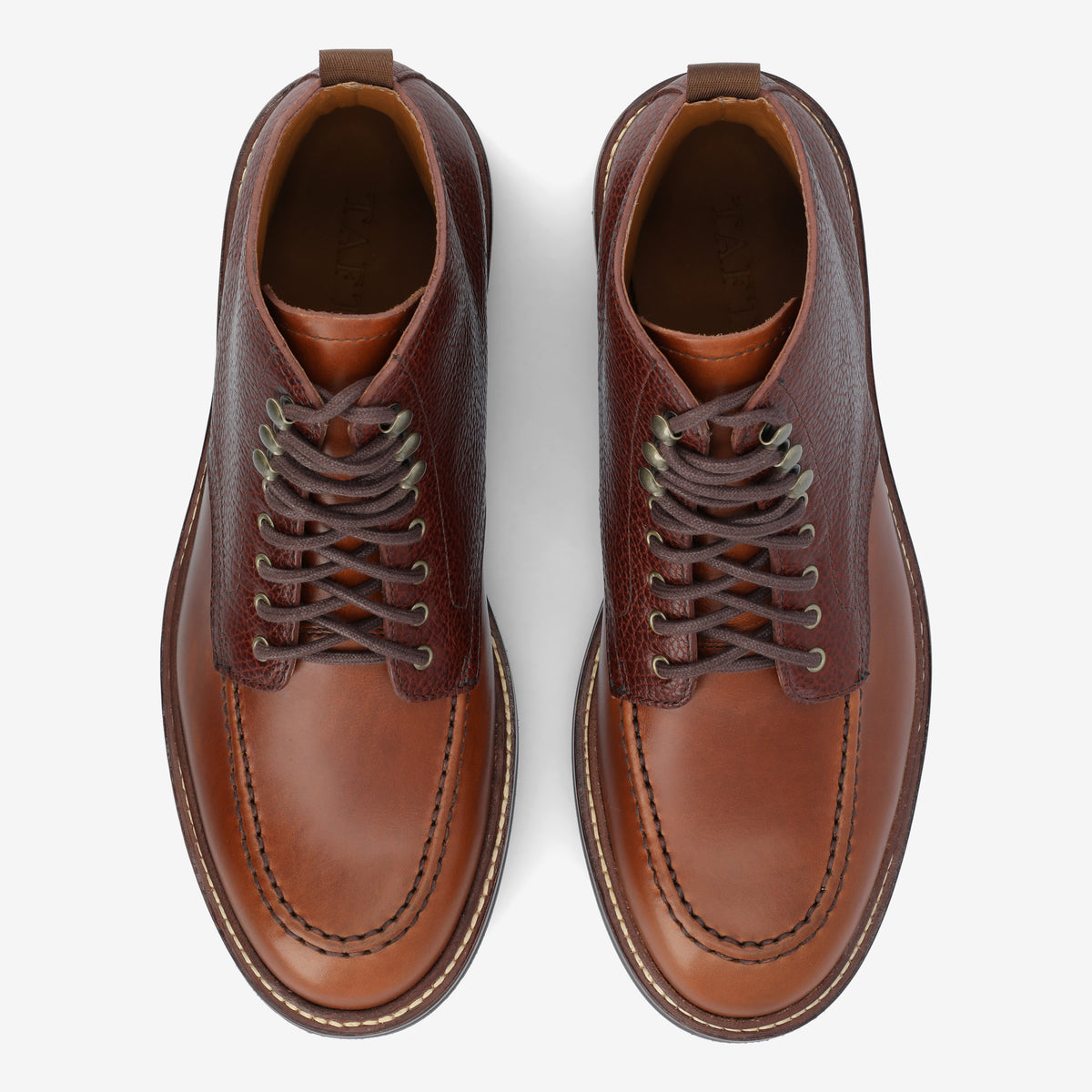 A pair of brown leather ankle boots with laces, viewed from above on a white background.