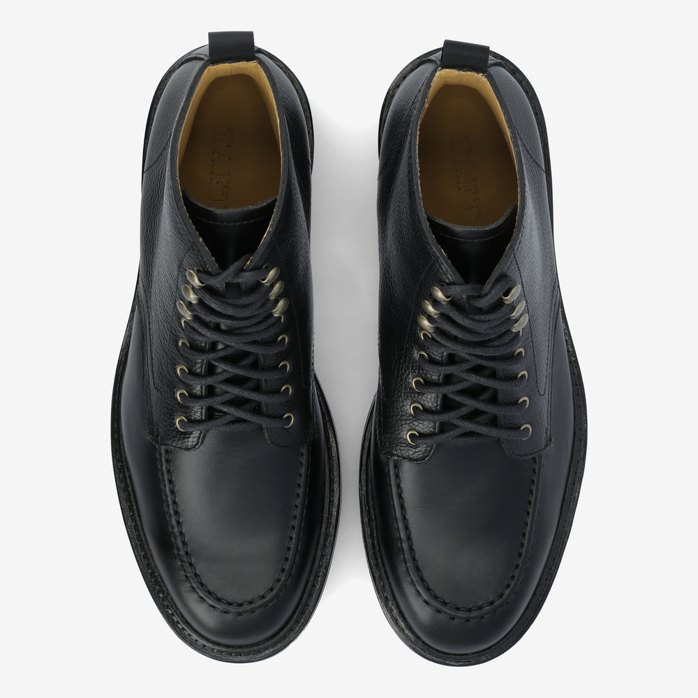 A pair of black leather lace-up shoes with a sleek design viewed from above on a white background.