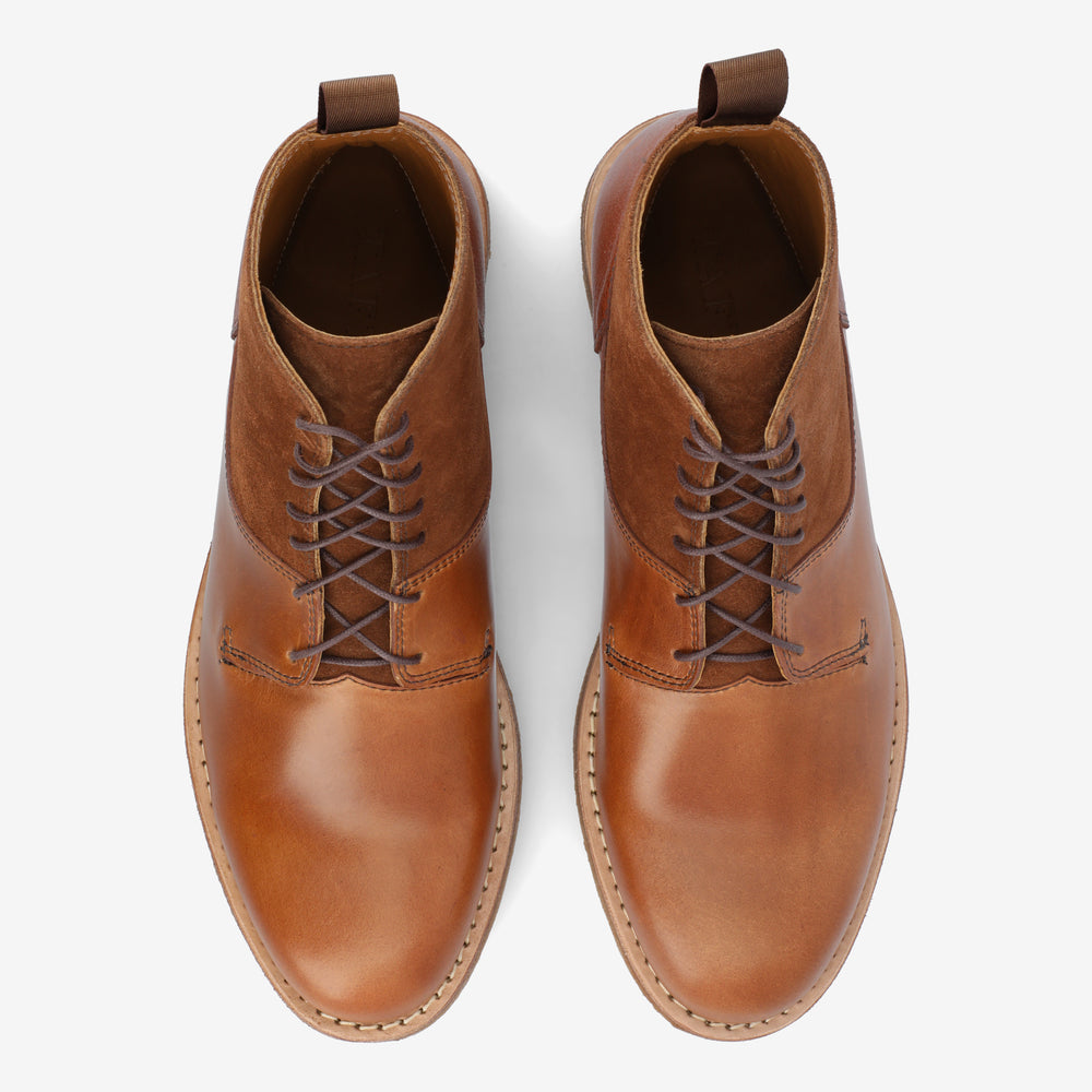 Top view of a pair of tan leather lace-up ankle boots with pull tabs at the back.