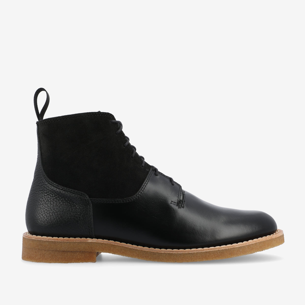 A black leather and suede lace-up ankle boot with a tan rubber sole.