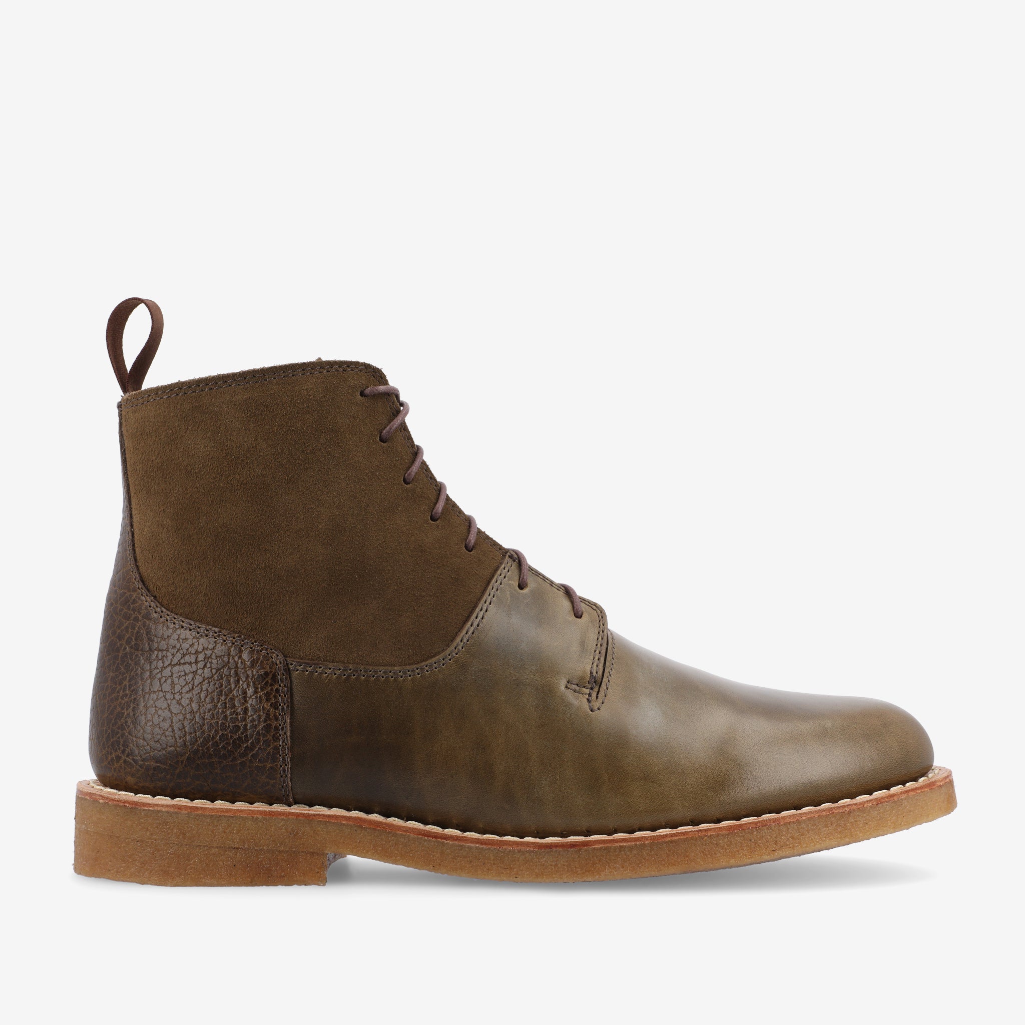 Side view of a brown leather and suede lace-up boot with a tan rubber sole.