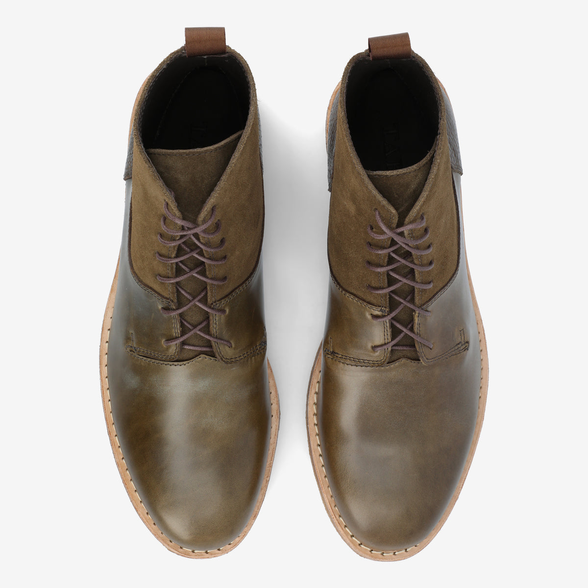 Top view of a pair of brown leather lace-up boots with a slightly worn look, placed on a white background.