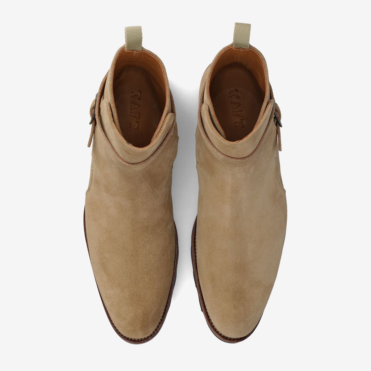 Top view of a pair of tan suede ankle boots, showing stitching details and side zipper closures.