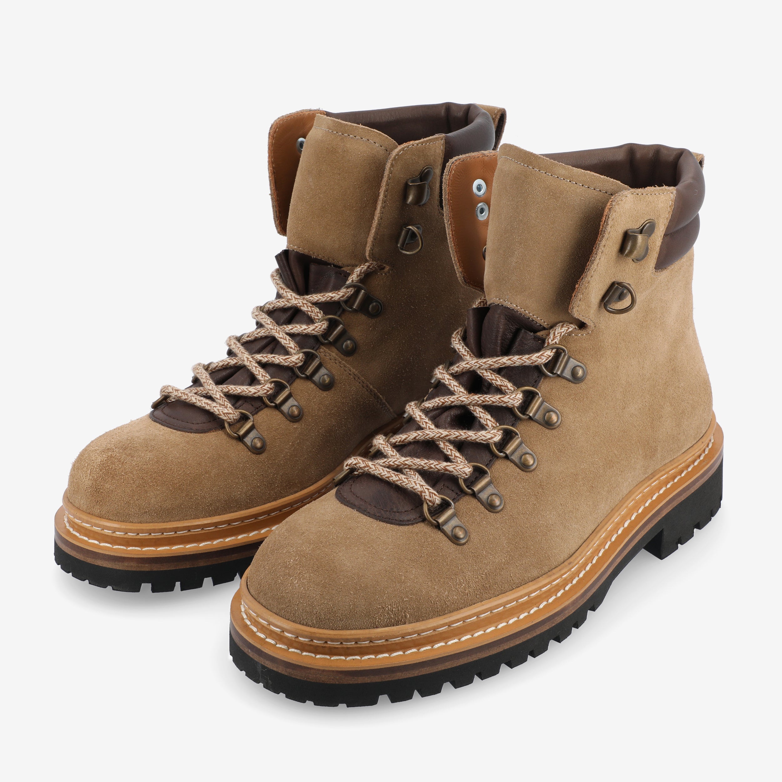 A pair of tan, lace-up hiking boots with thick rubber soles and dark brown accents.