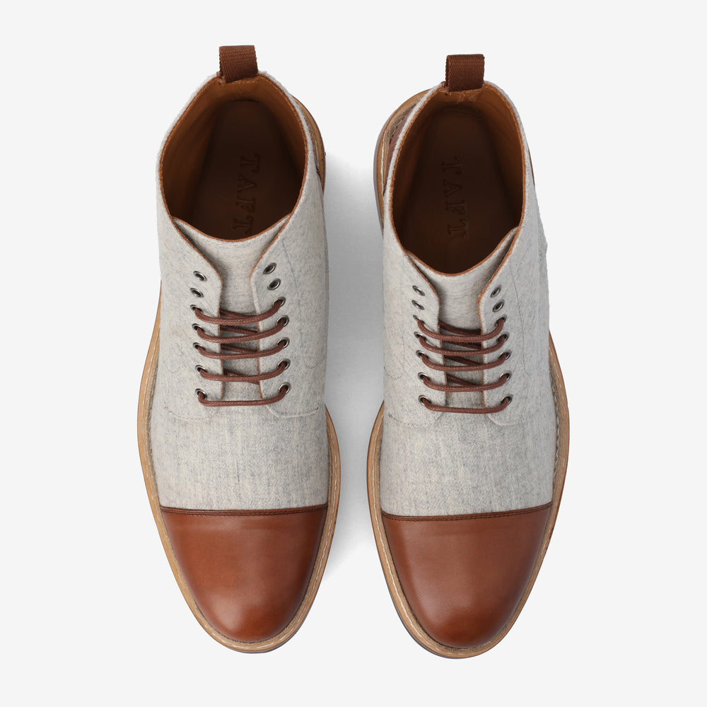 Top view of a pair of grey and brown leather lace-up ankle boots with a wooden sole, placed on a white background.