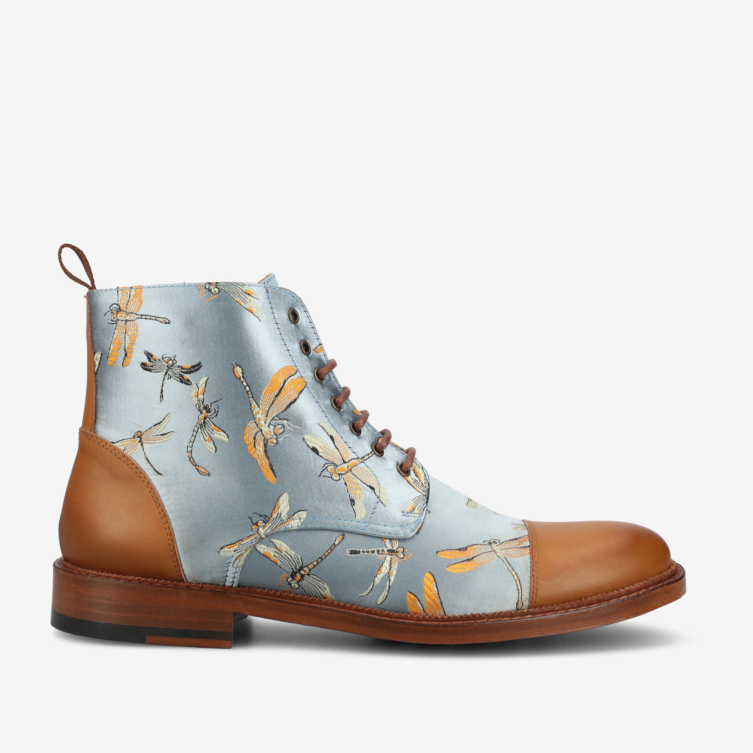 A lace-up boot with a brown leather toe and heel, featuring a light blue upper with an orange and black dragonfly pattern.