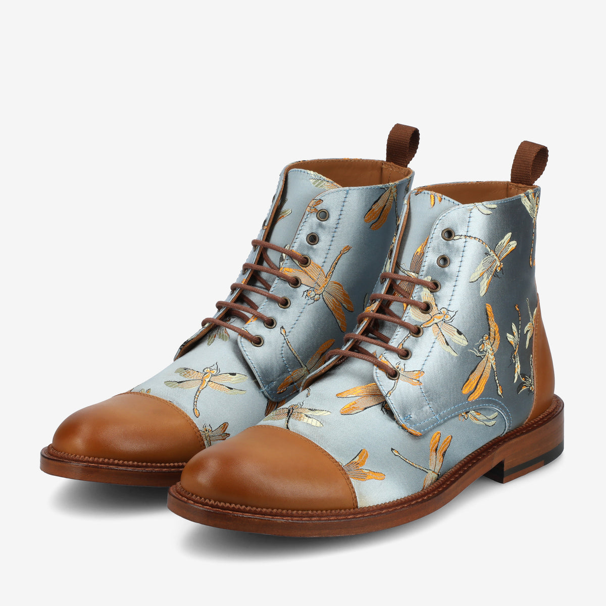 A pair of blue leather boots with brown toe caps and heel accents, featuring a dragonfly print design and brown laces.