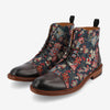 Pair of men's ankle boots with a dark leather toe cap and patterned floral fabric sides, featuring brown laces and soles.