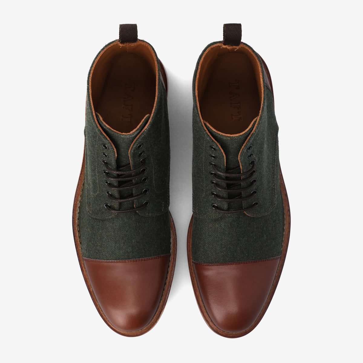 A pair of two-tone, lace-up men's dress shoes with green fabric and brown leather material on a white background.