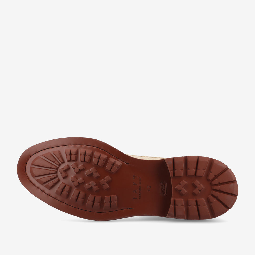 Bottom view of a brown shoe sole with a tread pattern designed for grip. The brand name and shoe size are embossed on the sole.