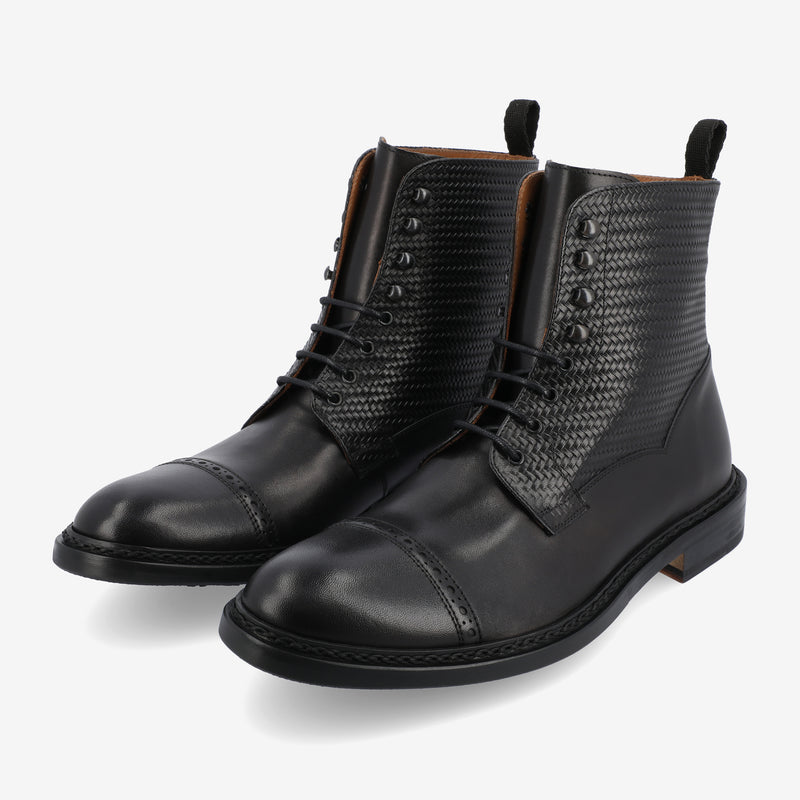 A pair of black leather lace-up boots with textured sides and toe caps, displayed on a white background.