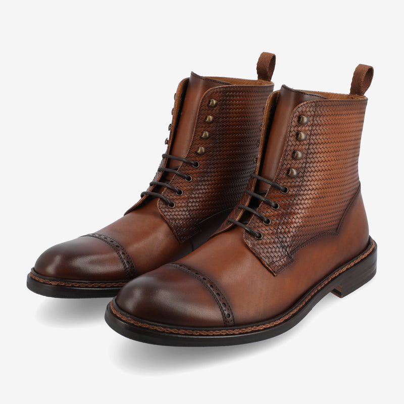 A pair of brown leather lace-up boots with textured sides and polished toe caps, set against a white background.