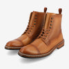 A pair of tan leather lace-up boots featuring a textured pattern on the sides and a cap toe design.