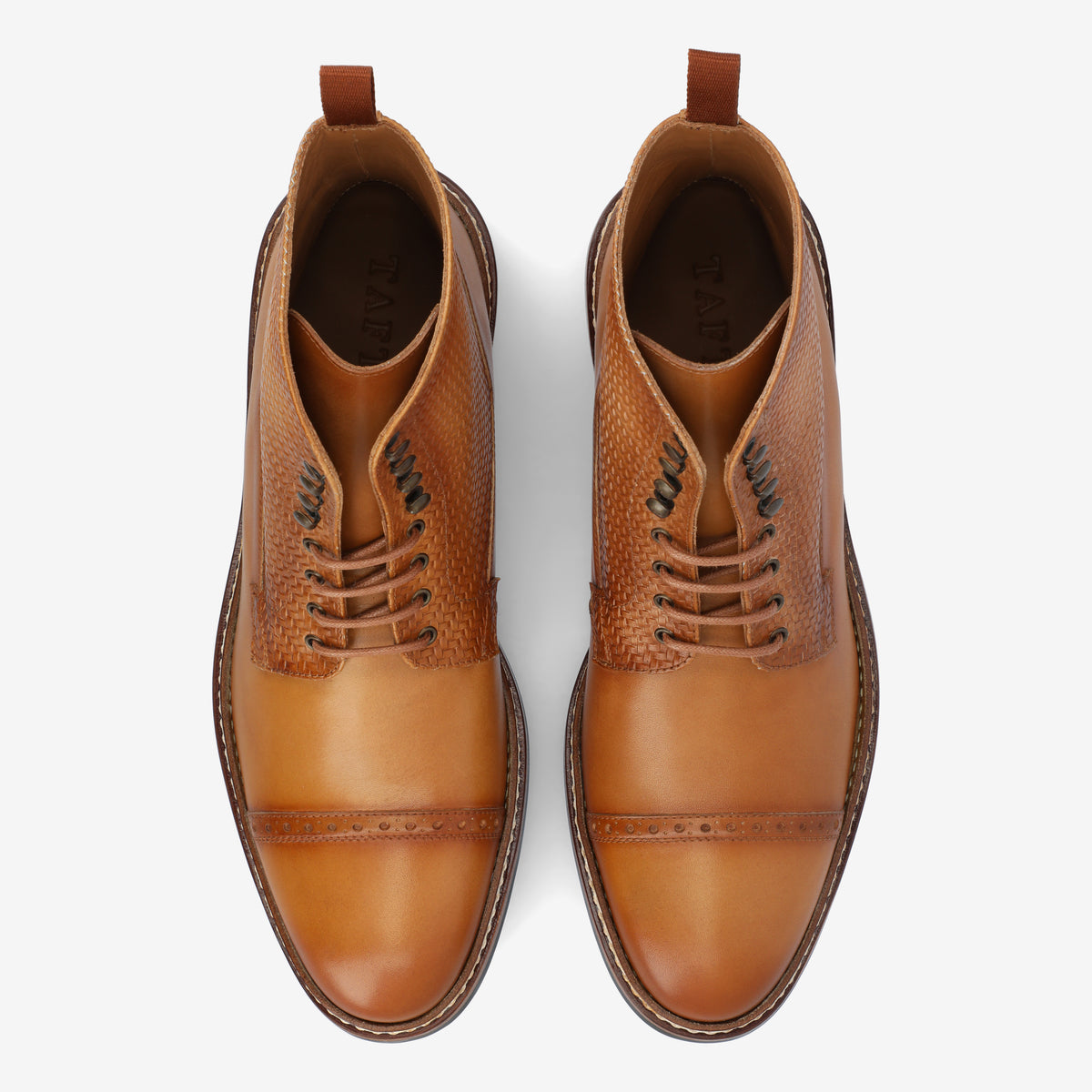 Top view of a pair of tan leather dress boots with detailed stitching and laces, placed side by side.