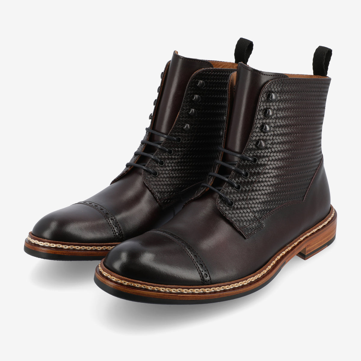 Black leather dress boots with detailed stitching, textured side panels, and wooden soles.