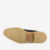 The sole of a shoe with a light tan, textured surface and a stitched leather patch featuring the brand name 'TAFT'.