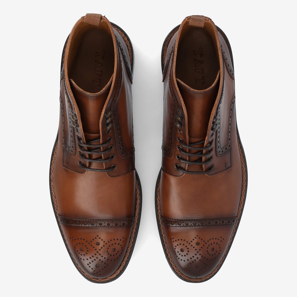 A pair of brown leather dress shoes with decorative perforations and laces, viewed from above.