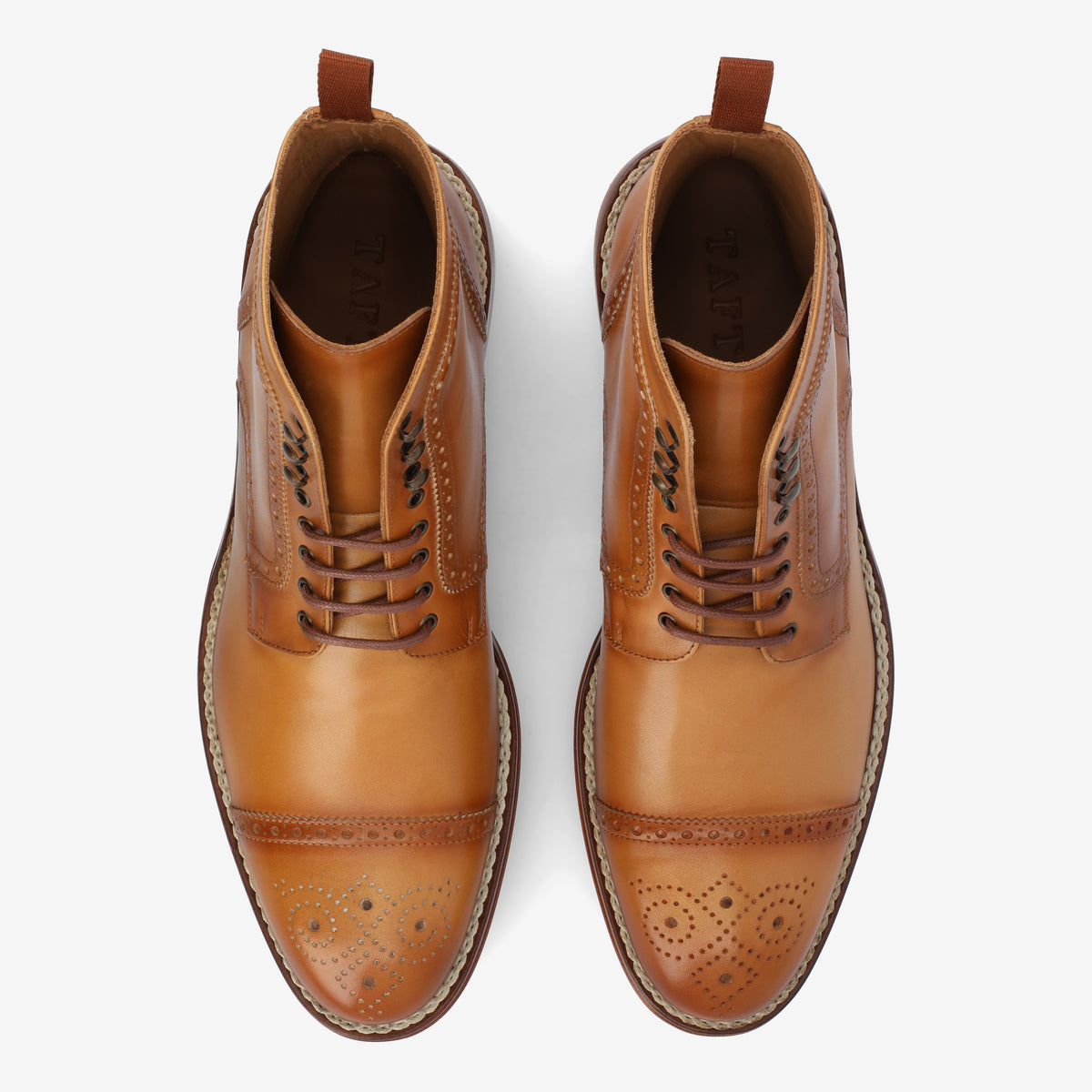 Top view of a pair of brown leather dress shoes with perforations on the toe caps and laces, placed side by side on a white background.