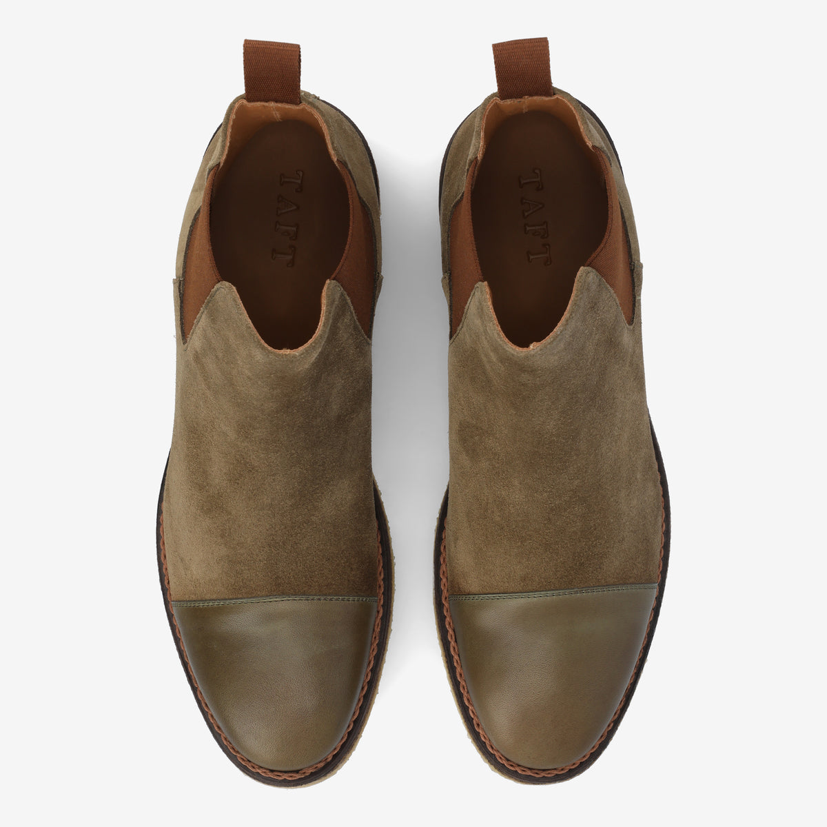 Top view of a pair of brown and olive green suede and leather shoes with pull tabs at the back and the brand name TAFT on the insoles.