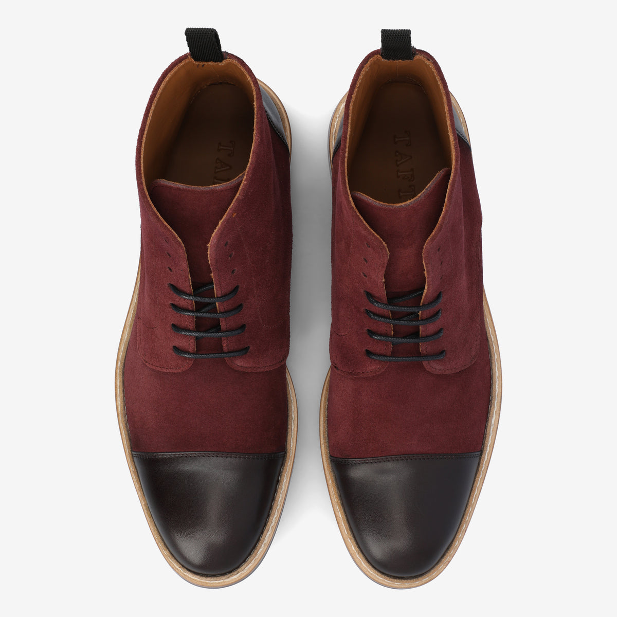 A pair of brown and burgundy suede lace-up shoes viewed from above, with tan soles and black toe caps.