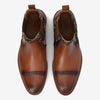 A pair of brown leather dress shoes with dark patterned side panels, top view.