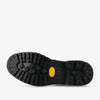 The sole of a black boot with tread pattern, yellow Vibram logo, and the brand name TAFT along with size number imprinted.