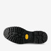 Close-up view of the sole of a black Taft boot, featuring a rugged tread pattern and a Vibram logo.