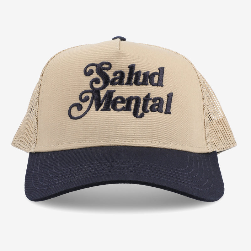 A beige and black trucker hat with the words Salud Mental embroidered on the front.