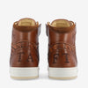 A pair of brown leather high-top sneakers with intricate woven detailing and embroidery, displaying the letters TAFT on the back.