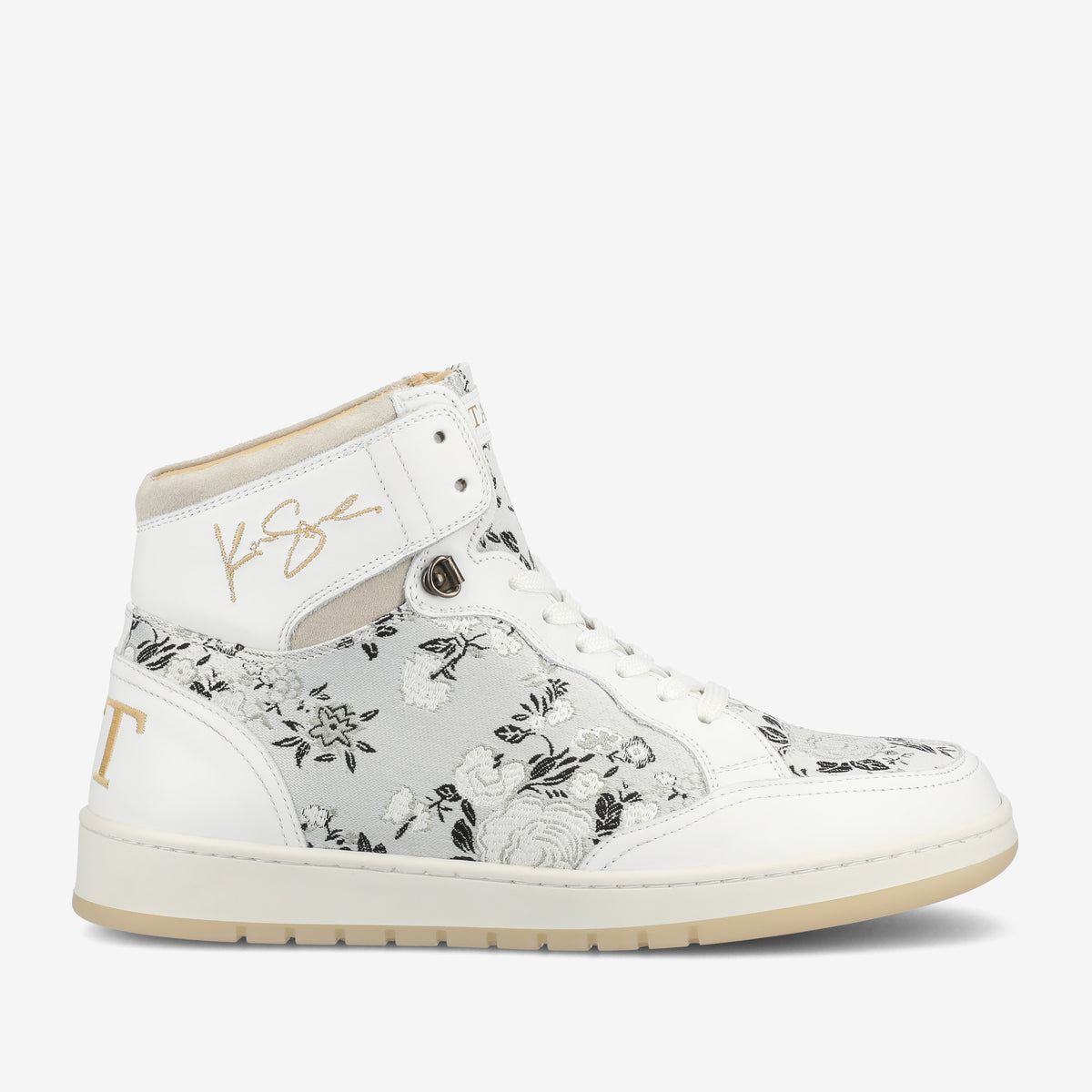 White high-top sneaker with floral pattern, with embroidered gold lettering and a signature on the upper side.