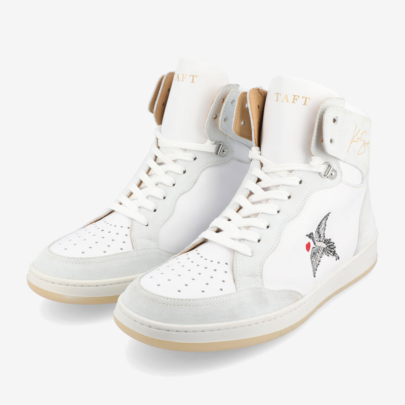 White high-top sneakers with suede accents, bird and heart design, and TAFT branding on the tongue and side.