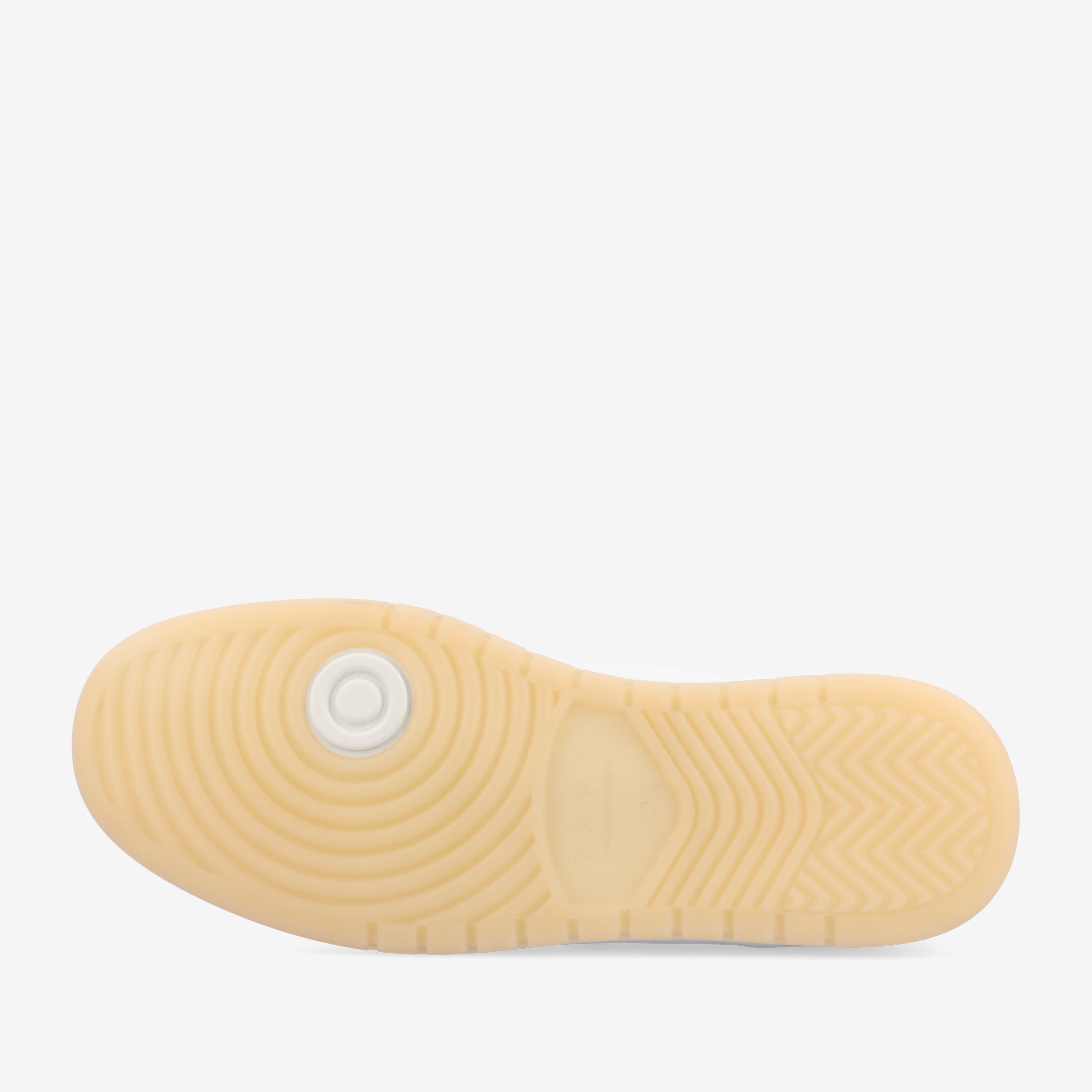 The image shows the beige sole of a sneaker, featuring grooves and patterns for traction, with a circular design near the heel.