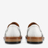 Back view of a pair of white leather loafers with wooden soles and black patterned details.