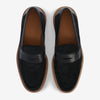 A pair of black leather loafers with brown soles, viewed from above.