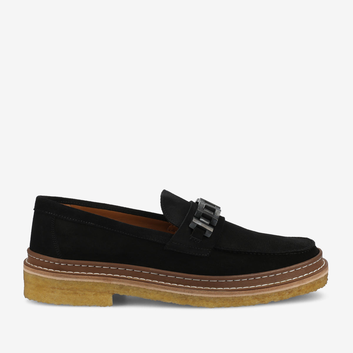 A black suede loafer with a metal buckle, contrasting brown stitch details, and a thick rubber sole.