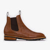 Brown leather Chelsea boot with black elastic side panels, pull tabs, and a wooden heel on a white background.