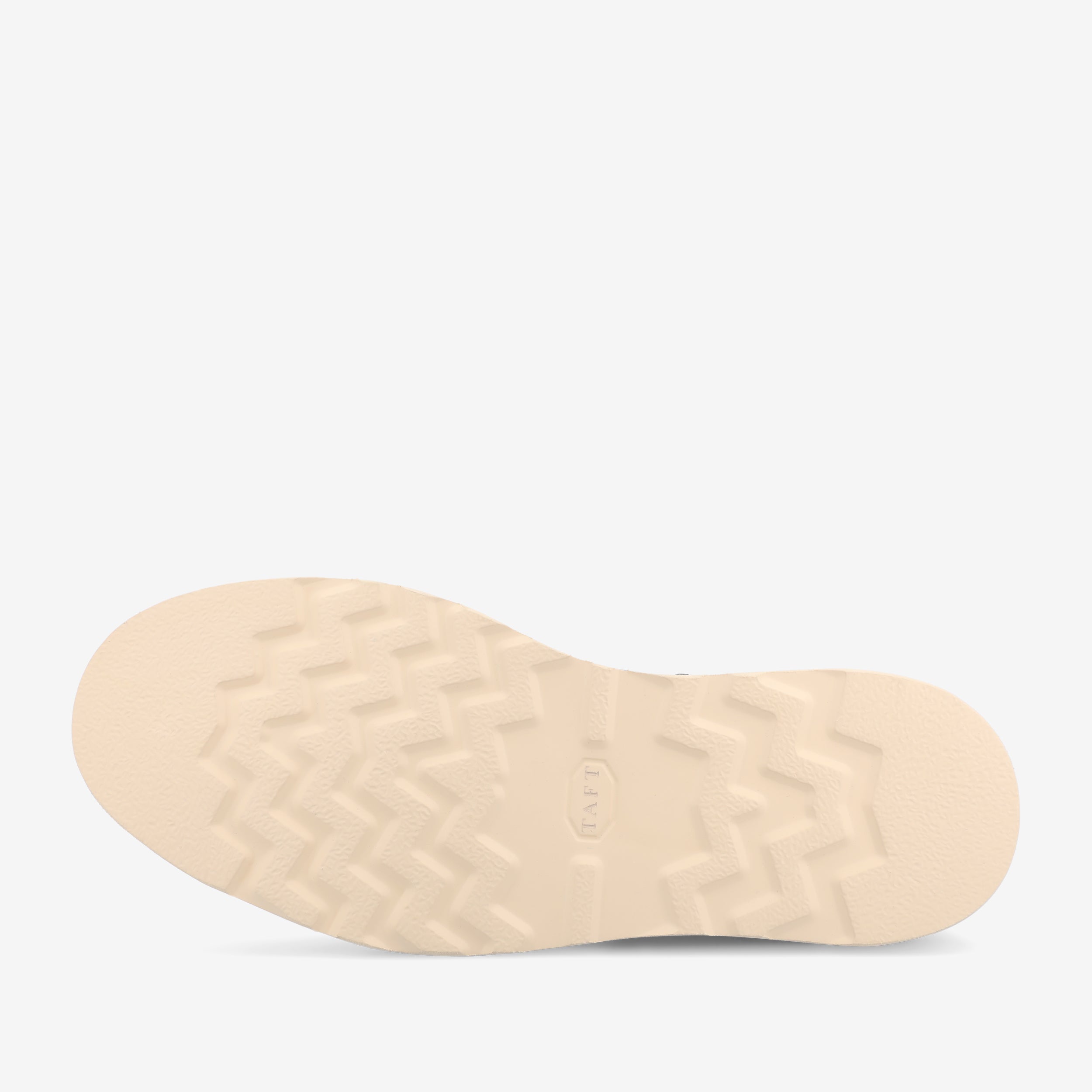 A close-up view of a beige shoe sole with a zigzag tread pattern and the word TAFT embossed in the center.